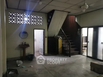 Spacious interior with staircase and vintage charm, ideal for renovation projects.