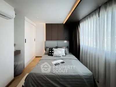 Modern bedroom with sleek design and ample natural light