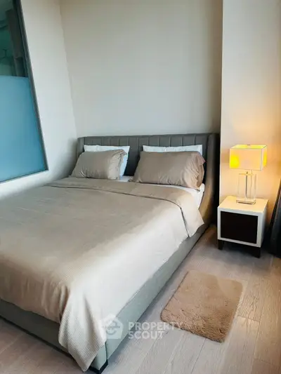 Cozy modern bedroom with stylish decor and ambient lighting, perfect for relaxation and comfort.