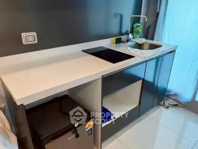 Modern kitchen with sleek countertop and built-in appliances in a stylish apartment.