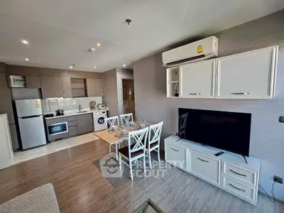 Modern open-plan living room with kitchen, dining area, and stylish decor