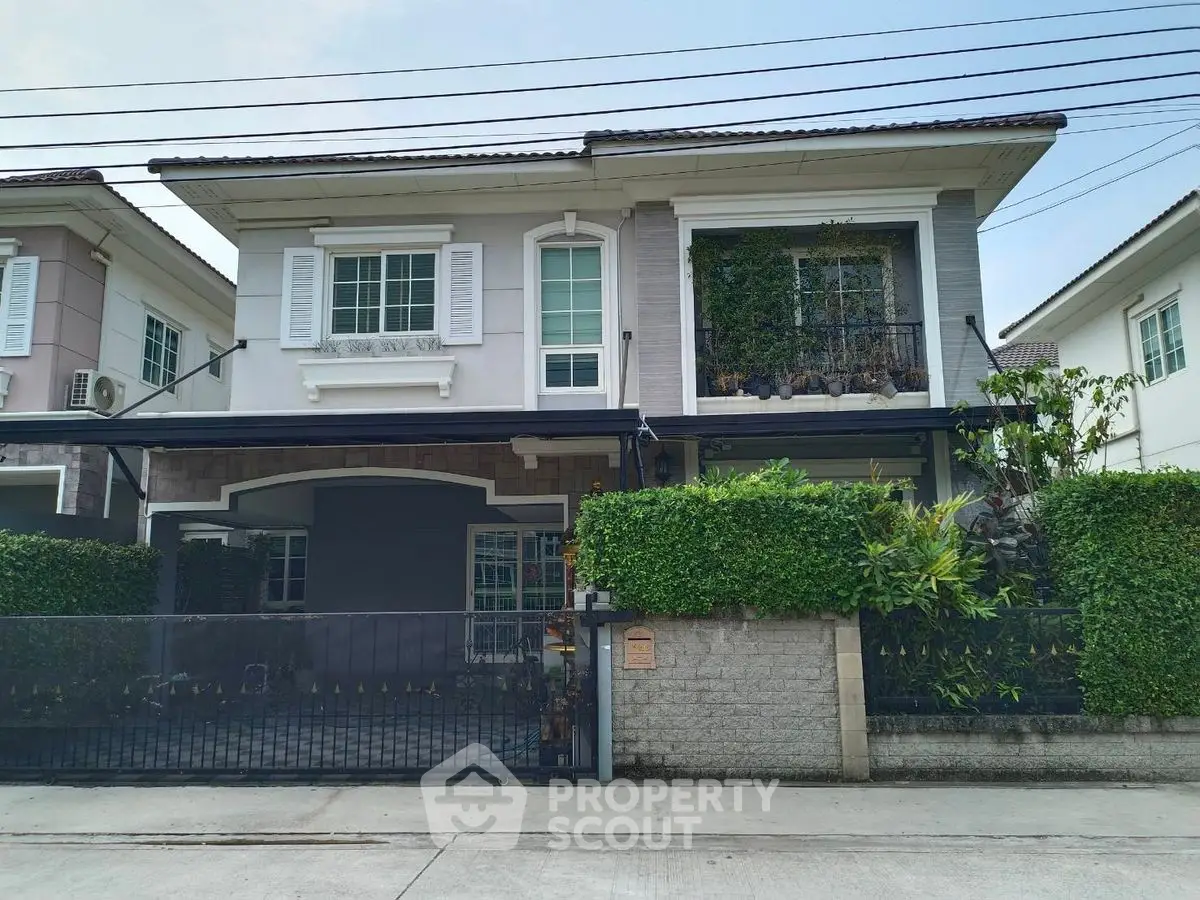 Charming two-story house with lush greenery and modern facade in a serene neighborhood.