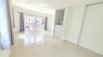 Spacious bright room with large windows and sliding doors, perfect for modern living.