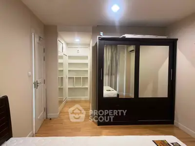 Spacious bedroom with walk-in closet and modern wardrobe design