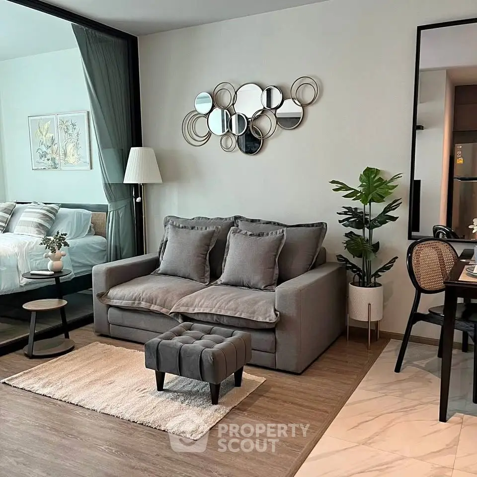 Modern living room with stylish decor, cozy sofa, and elegant wall art in a contemporary apartment.