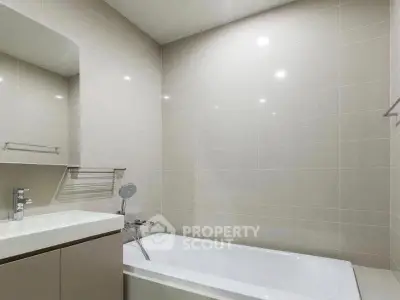 Modern bathroom with sleek design and bathtub in a contemporary home.