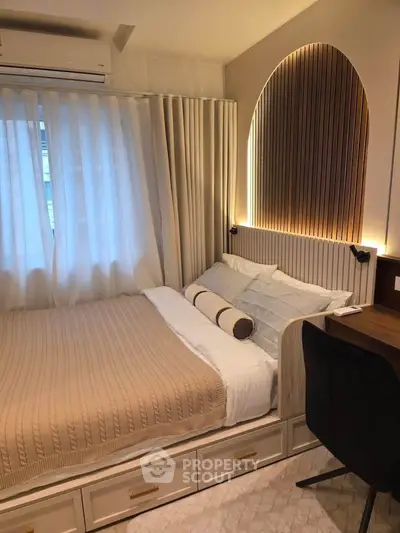 Cozy bedroom with elegant lighting and stylish decor, featuring a comfortable bed and modern furnishings.