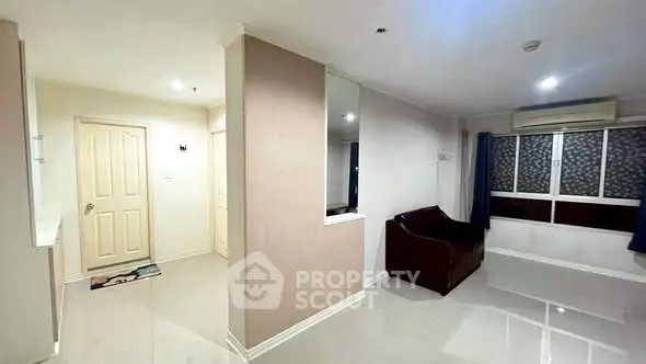 Spacious living room with modern design and large windows for natural light.