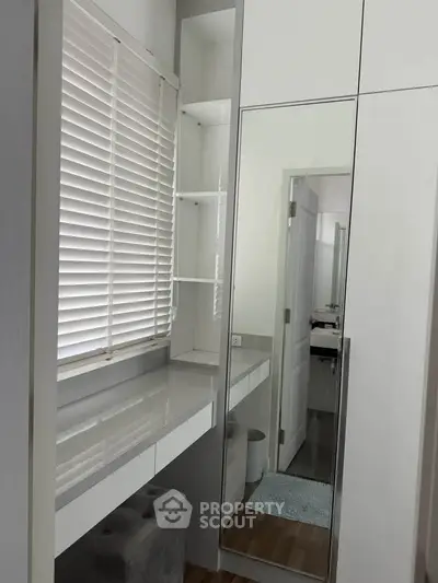 Modern bedroom with sleek built-in wardrobe and stylish blinds, perfect for contemporary living.