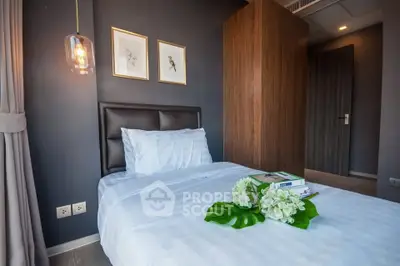 Cozy bedroom with modern decor and soft lighting, perfect for relaxation.