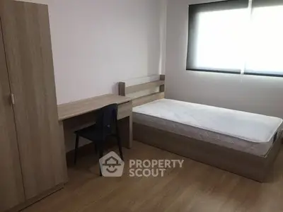 Minimalist bedroom with wooden furniture and natural light