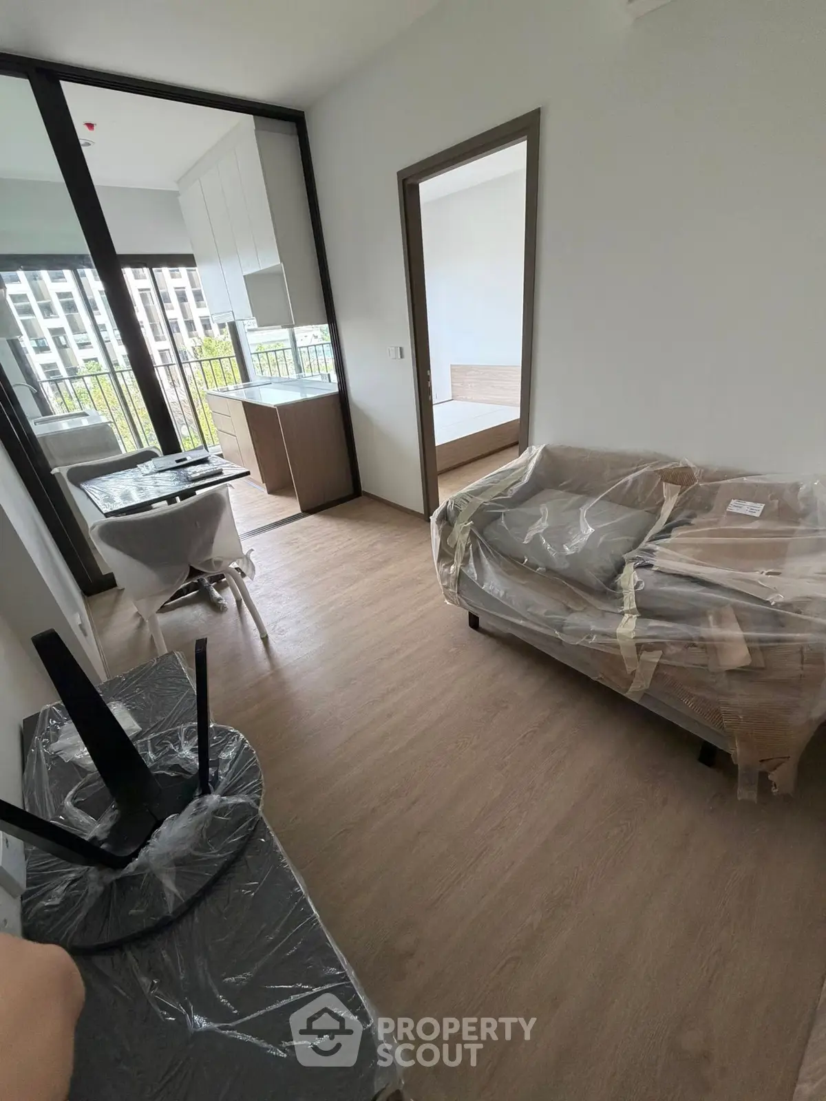 Modern apartment interior with open layout and balcony view