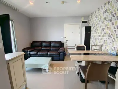 Modern living room with stylish furniture and unique accent wall in a cozy apartment.
