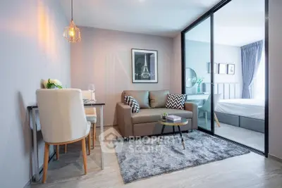 Modern living room with cozy seating and stylish decor adjacent to a bedroom.