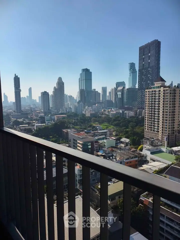 Stunning cityscape view from a high-rise balcony overlooking urban skyline.