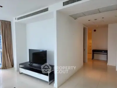Spacious modern living area with sleek TV stand and natural light