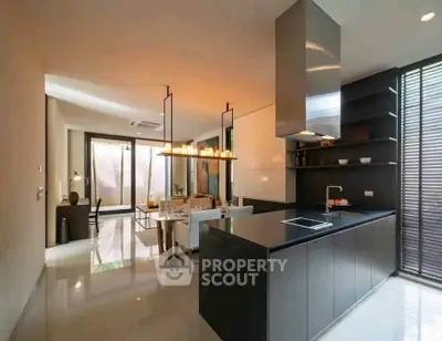 Modern open-layout kitchen with sleek design and spacious living area