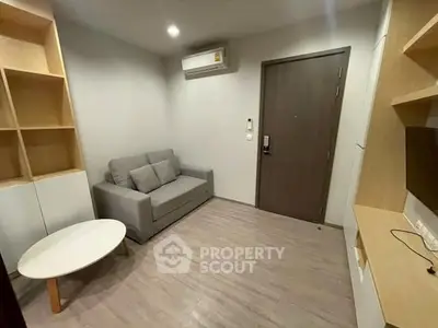 Modern living room with sleek design and cozy sofa in a compact apartment.