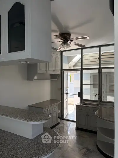 Modern kitchen with open layout and granite countertops