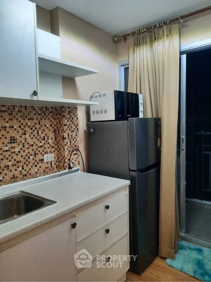 Modern kitchen with mosaic backsplash and balcony access