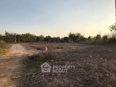 Expansive vacant land with potential for development, surrounded by greenery and a serene environment.