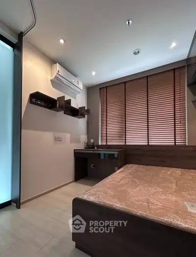 Modern bedroom with air conditioning and wooden blinds, featuring sleek furniture and ambient lighting.