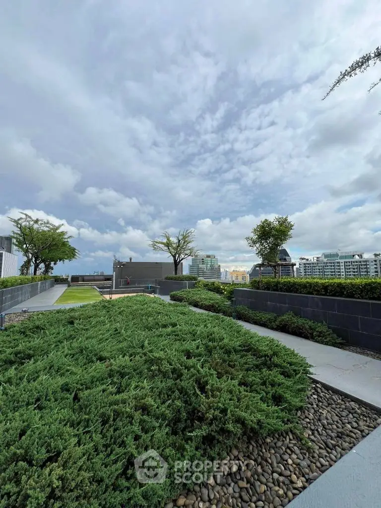 Stunning rooftop garden with lush greenery and city skyline views.