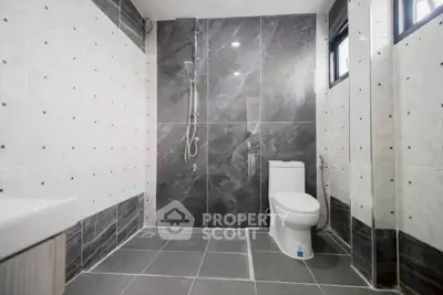 Modern bathroom with sleek gray tiles and walk-in shower