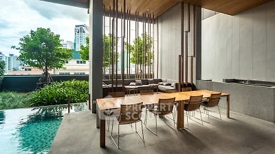 Luxurious outdoor dining area with pool and city view, perfect for entertaining.