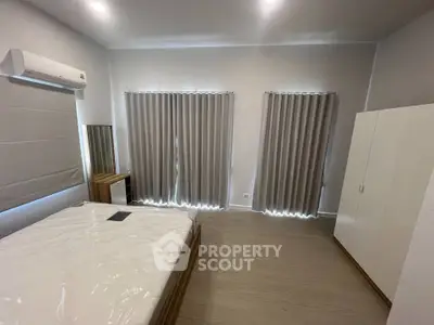 Spacious bedroom with modern furnishings and natural light