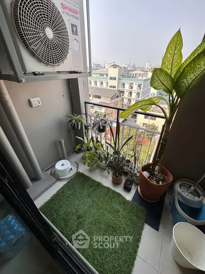 Charming balcony with lush plants and city view, perfect for relaxation and enjoying urban living.