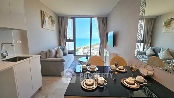 Luxurious living room with ocean view, elegant decor, and modern kitchen in a high-rise apartment.
