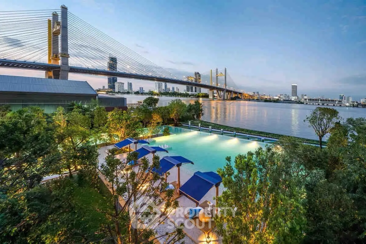 Luxurious riverside pool with stunning bridge view, perfect for relaxation and leisure in a serene environment.