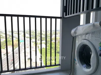 Modern balcony with washing machine and city view, perfect for urban living convenience.