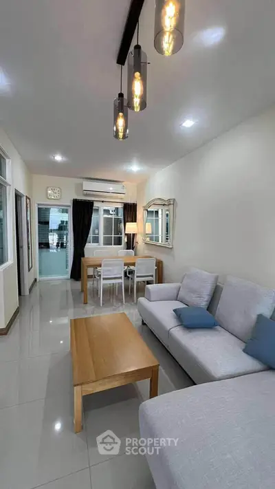 Modern living room with sleek furniture and stylish lighting in a cozy apartment.