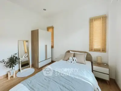 Cozy minimalist bedroom with natural light and modern decor