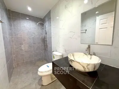 Modern bathroom with elegant marble sink and spacious shower area