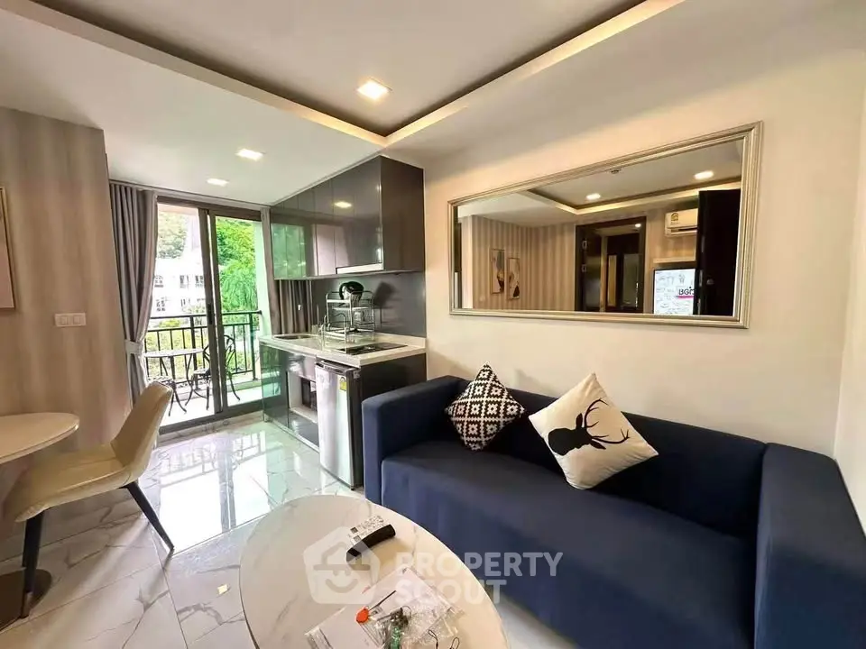 Modern living room with open kitchen and balcony view in stylish apartment