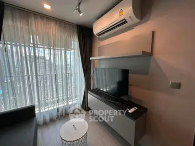 Modern living room with large window, air conditioning, and sleek TV setup