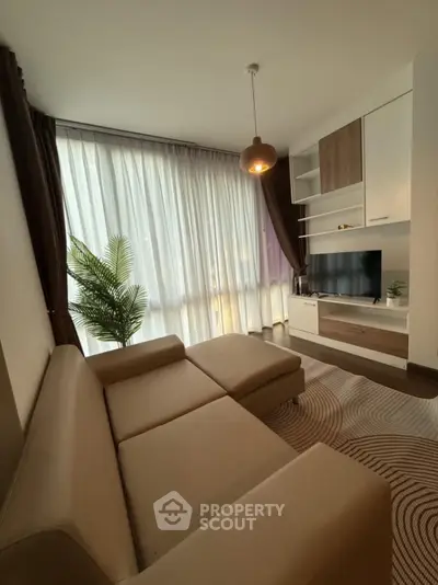 Modern living room with large windows and stylish furniture