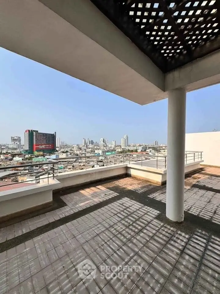 Spacious rooftop terrace with stunning city skyline views, perfect for outdoor relaxation and entertainment.