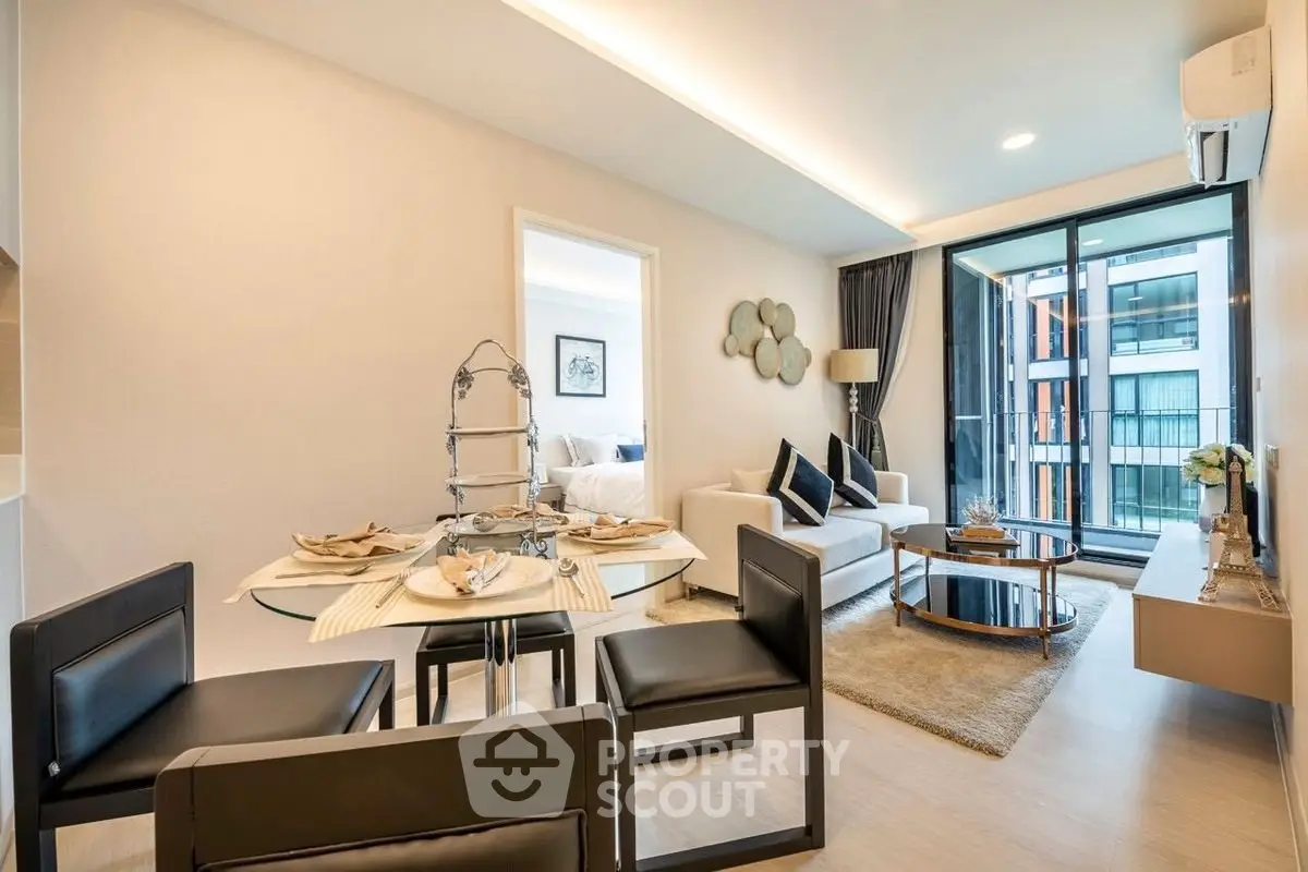 Modern living room with elegant dining area and large windows in a stylish apartment.