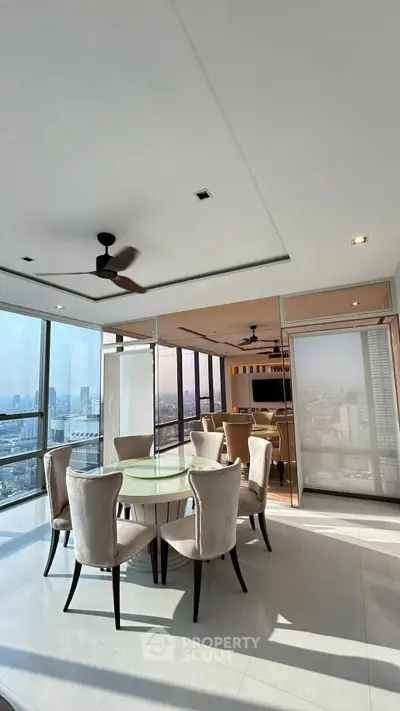 Luxurious high-rise dining area with panoramic city views and elegant furnishings.