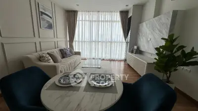 Luxurious modern living room with elegant decor and large windows