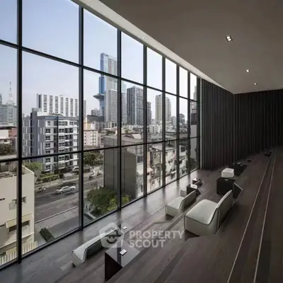 Luxurious modern living room with panoramic city view through floor-to-ceiling windows.