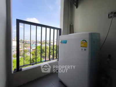 Compact balcony with washing machine and scenic city view