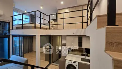 Modern loft apartment with mezzanine, open kitchen, and stylish interior design.