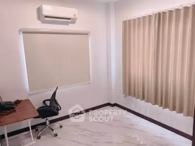 Modern study room with sleek desk, ergonomic chair, and air conditioning in a bright, minimalist design.