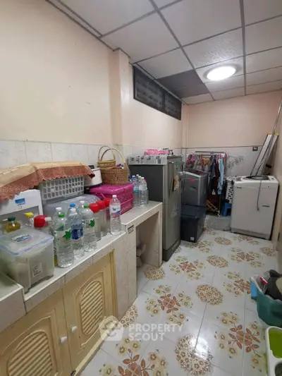 Spacious utility room with washing machine and ample storage space