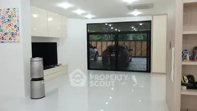Spacious modern living room with large sliding doors and sleek interior design.
